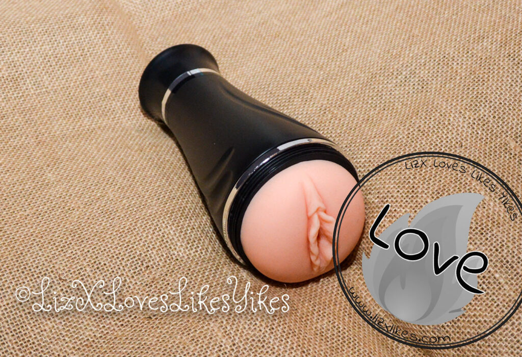 BestVibe Review of Vibrating Double Labia Male Masturbator The full masturbator is shown here with the stamp 'Love' Copyright Liz BlackX