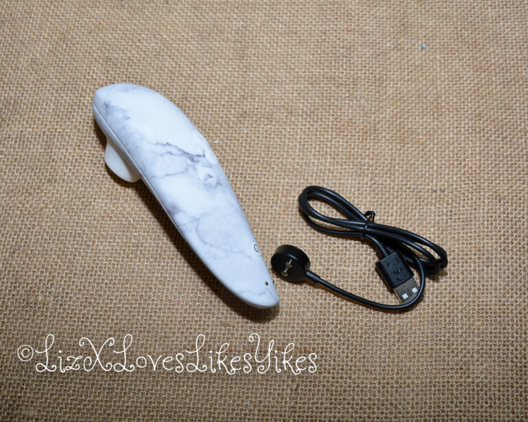 The Womanizer with its charging cable. Review of the Womanizer Marilyn Monroe Special Edition Copyright Liz BlackX