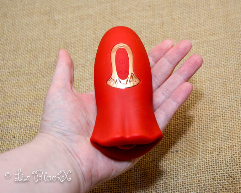 The vibrator seen in my open hand. Licking & Sucking Vibrator from Inyarose - A Giggle-Inducing Orgasmic Experience Copyright Liz BlackX